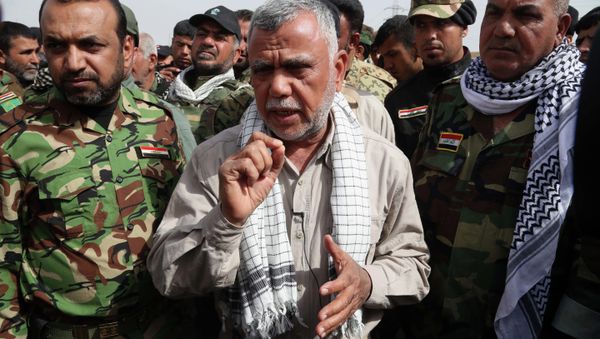 Hadi al-Amiri commander, center, of Iraq's powerful Shiite militias speaks during an interview with The Associated Press on the battlefield near the Iraqi city of Tikrit, 80 miles (130 kilometers) north of Baghdad, Iraq, Friday, March 13, 2015. Al-Amiri accused the U.S. of falling short on promises to help Iraq in its battle against the Islamic State group and called Iranian assistance to Iraqi security forces unconditional. - Sputnik International