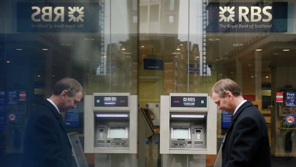 A pedestrian is reflected in an advertising board as he walks past a branch of The Royal Bank of Scotland in central London - Sputnik International