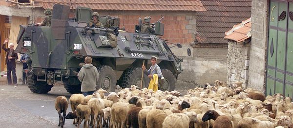 A German armoured vehicle part of the NATO-led KFOR troops drives past a herd of sheep 17 June 1999 in Orahovac, south western Kosovo. A German armoured vehicle part of the NATO-led KFOR troops drives past a herd of sheep 17 June 1999 in Orahovac, south western Kosovo. - Sputnik International