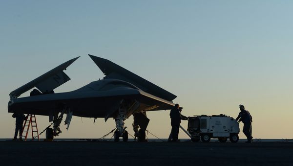 Sailors working on an X-47B Unmanned Combat Air System (UCAS) at dawn aboard the aircraft carrier USS George H.W. Bush Sailors working on an X-47B Unmanned Combat Air System (UCAS) at dawn aboard the aircraft carrier USS George H.W. Bush - Sputnik International