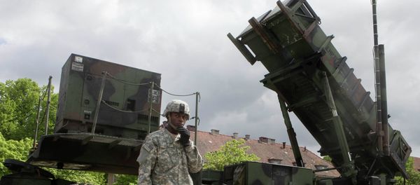 US soldier stands next to a Patriot surface-to-air missile battery at an army base in Morag, Poland US soldier stands next to a Patriot surface-to-air missile battery at an army base in Morag, Poland - Sputnik International