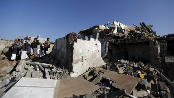 People gather at the site of an air strike at a residential area near Sanaa Airport March 26, 2015. - Sputnik International