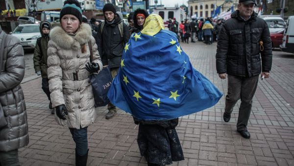 A woman is walking with the EU flag on her back A woman is walking with the EU flag on her back - Sputnik International