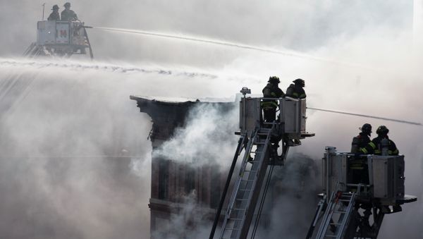 Firefighters spray water on a collapsed building in New York's East Village Firefighters spray water on a collapsed building in New York's East Village - Sputnik International