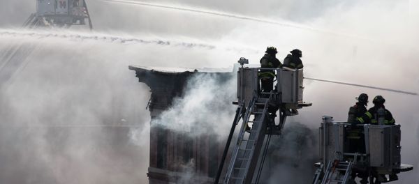 Firefighters spray water on a collapsed building in New York's East Village Firefighters spray water on a collapsed building in New York's East Village - Sputnik International