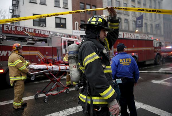 New York City Fire Department firefighters walk towards the site of a residential apartment building collapse and fire in New York City's East Village neighborhood New York City Fire Department firefighters walk towards the site of a residential apartment building collapse and fire in New York City's East Village neighborhood - Sputnik International