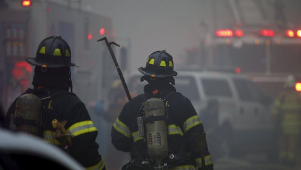New York City Fire Department firefighters walk towards the site of a residential apartment building collapse and fire in New York City's East Village neighborhood New York City Fire Department firefighters walk towards the site of a residential apartment building collapse and fire in New York City's East Village neighborhood - Sputnik International