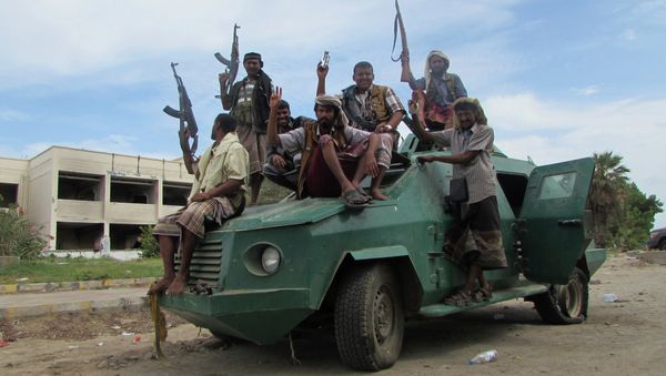 Militiamen loyal to President Abed Rabbo Mansour Hadi ride on an army vehicle on a street in Aden, Yemen - Sputnik International