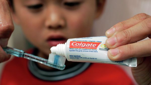 Yvonne Chu puts Colgate toothpaste on a tooth brush for her son, Skyler Fong, 6, in Palo Alto, Calif. Yvonne Chu puts Colgate toothpaste on a tooth brush for her son, Skyler Fong, 6, in Palo Alto, Calif. - Sputnik International