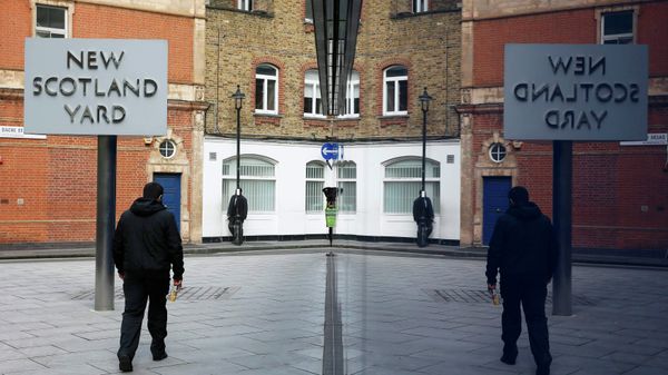 A man walks past the rotating triangular sign outside New Scotland Yard in central London March 17, 2015 - Sputnik International