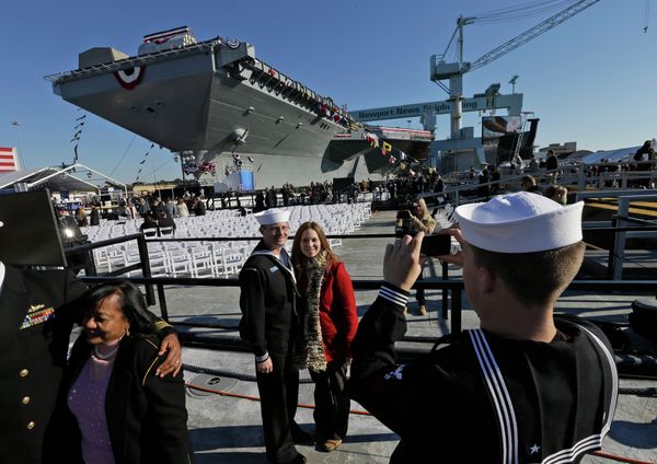 People pose for photos in front of Navy aircraft carrier USS Gerald R. Ford during the christening of the ship in November 2013. People pose for photos in front of Navy aircraft carrier USS Gerald R. Ford during the christening of the ship in November 2013. - Sputnik International
