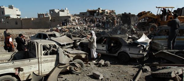 Yemenis stand at the site of a Saudi air strike against Huthi rebels near Sanaa Airport on March 26, 2015, which killed at least 13 people Yemenis stand at the site of a Saudi air strike against Huthi rebels near Sanaa Airport on March 26, 2015, which killed at least 13 people - Sputnik International