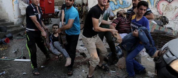Palestinians help carry injured men following an Israeli Strike in Shijaiyah neighborhood, eastern Gaza City, last July. Palestinians help carry injured men following an Israeli Strike in Shijaiyah neighborhood, eastern Gaza City, last July. - Sputnik International