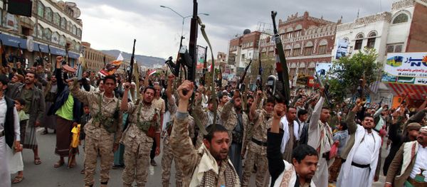 Shiite rebels, known as Houthis, hold up their weapons to protest against Saudi-led airstrikes, as they chant slogans during a rally in Sanaa, Yemen, Thursday, March 26, 2015 Shiite rebels, known as Houthis, hold up their weapons to protest against Saudi-led airstrikes, as they chant slogans during a rally in Sanaa, Yemen, Thursday, March 26, 2015 - Sputnik International