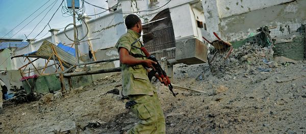 A solder walks past at the scene of a car bomb attack and armed raid by Al Shebab militants on the Maka al Mukarama hotel in Mogadishu - Sputnik International