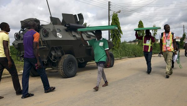 Officials of the Independent National Electoral Commission move electoral materials to the polling booths in Otuoke, Bayelsa State March 28, 2015 - Sputnik International