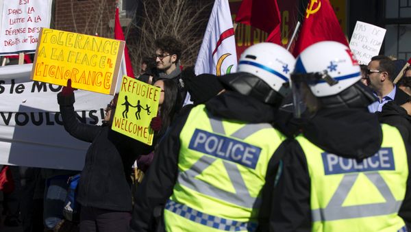 Police watch as a group of people rally to denounce a planned march by the Patriotic Europeans Against the Islamization of the West (PEGIDA) in Montreal March 28, 2015 Police watch as a group of people rally to denounce a planned march by the Patriotic Europeans Against the Islamization of the West (PEGIDA) in Montreal March 28, 2015 - Sputnik International