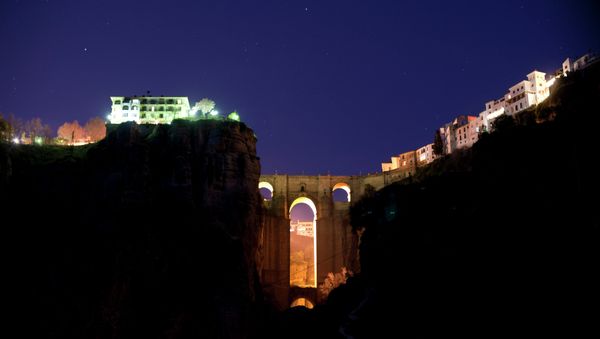 The New Bridge of Ronda is enlightened from behind during the global climate change awareness campaign Earth Hour, on March 28, 2015 - Sputnik International