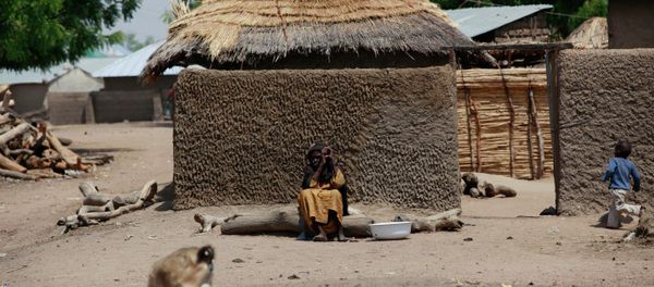 Woman sits outside her home in Chibok, Borno Woman sits outside her home in Chibok, Borno - Sputnik International