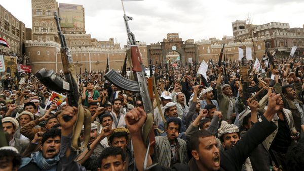 Shi'ite Muslim rebels hold up their weapons during a rally against air strikes in Sanaa Shi'ite Muslim rebels hold up their weapons during a rally against air strikes in Sanaa - Sputnik International