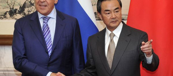 Russian Foreign Minister Sergey Lavrov (L) shakes hands with Chinese Foreign Minister Wang Yi before their meeting at Diaoyutai Guesthouse in Beijing on April 15, 2014 Russian Foreign Minister Sergey Lavrov (L) shakes hands with Chinese Foreign Minister Wang Yi before their meeting at Diaoyutai Guesthouse in Beijing on April 15, 2014 - Sputnik International