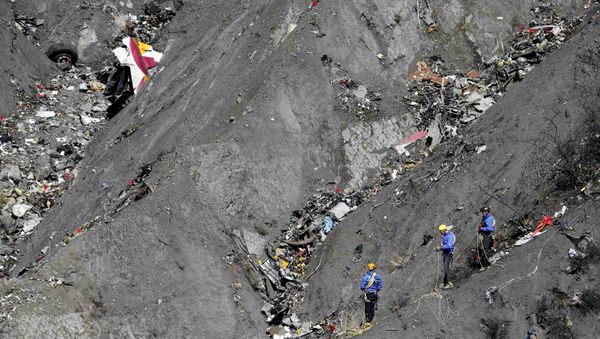 French gendarmes and investigators work amongst the debris of the Airbus A320 at the site of the crash, near Seyne-les-Alpes, French Alps March 26, 2015 - Sputnik International