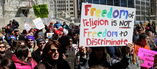 Demonstrators gather at Monument Circle to protest a controversial religious freedom bill recently signed by Governor Mike Pence during a rally in Indianapolis March 28, 2015 Demonstrators gather at Monument Circle to protest a controversial religious freedom bill recently signed by Governor Mike Pence during a rally in Indianapolis March 28, 2015 - Sputnik International