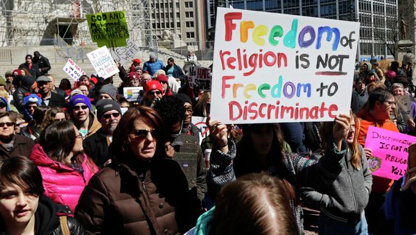 Demonstrators gather at Monument Circle to protest a controversial religious freedom bill recently signed by Governor Mike Pence during a rally in Indianapolis March 28, 2015 Demonstrators gather at Monument Circle to protest a controversial religious freedom bill recently signed by Governor Mike Pence during a rally in Indianapolis March 28, 2015 - Sputnik International