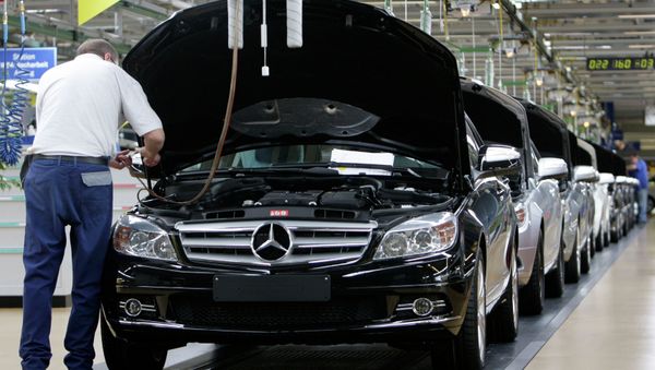 An employee of German car producer Mercedes-Benz controling a Mercedes C-class as it rolls off the production line in the plant in Sindelfingen near Stuttgart, Germany - Sputnik International