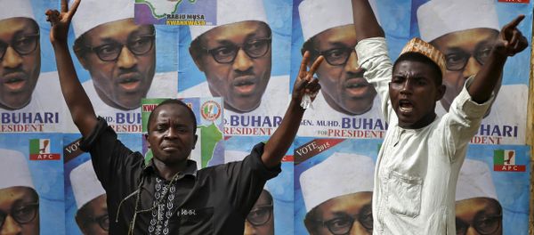 Supporters of presidential candidate Muhammadu Buhari gesture in front of his election posters in Kano - Sputnik International
