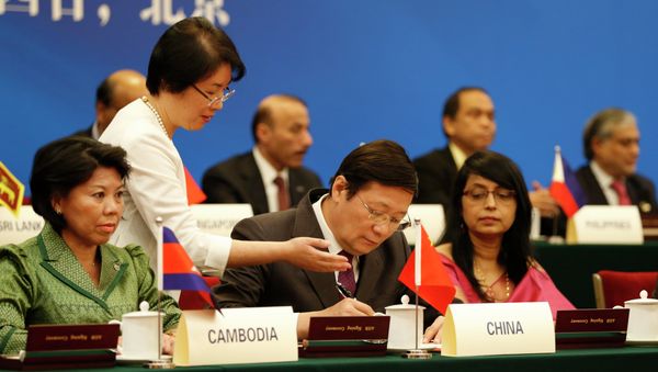 Chinese Finance Minister Lou Jiwei (C) signs with guests at the signing ceremony of the Asian Infrastructure Investment Bank at the Great Hall of the People in Beijing Chinese Finance Minister Lou Jiwei (C) signs with guests at the signing ceremony of the Asian Infrastructure Investment Bank at the Great Hall of the People in Beijing - Sputnik International