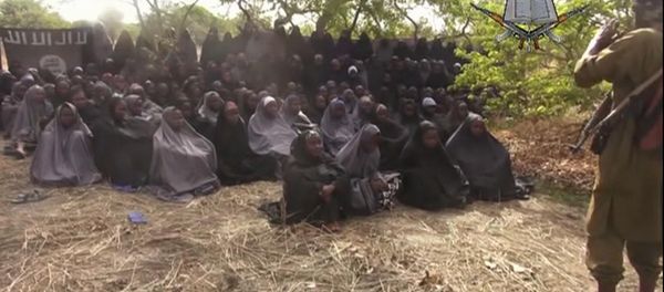 This Monday, May 12, 2014, file image taken from video by Nigeria's Boko Haram terrorist network, shows the alleged missing girls abducted from the northeastern town of Chibok. Islamic extremists in Nigeria have seized Chibok, forcing thousands of residents to flee the northeastern town from which the insurgents kidnapped nearly 300 schoolgirls in April. - Sputnik International