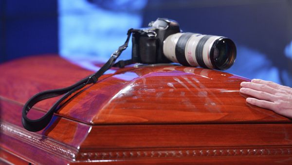 Mourning ceremony for the late photo journalist Andrei Stenin at the Rossiya Segodnya agency's press center. - Sputnik International