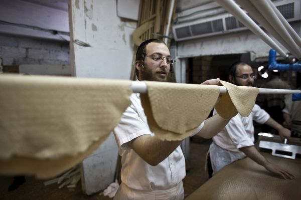 An ultra-Orthodox Jewish man places kneaded dough on a stick before it is placed in the oven to prepare matza, the traditional unleavened bread eaten during the Jewish holiday of Passover, in Bnei Brak near Tel Aviv An ultra-Orthodox Jewish man places kneaded dough on a stick before it is placed in the oven to prepare matza, the traditional unleavened bread eaten during the Jewish holiday of Passover, in Bnei Brak near Tel Aviv - Sputnik International