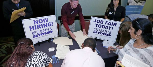 In this Oct. 22, 2014 file photo, job seekers fill out a job applications at a Bed Bath and Beyond table at a job fair in Miami Lakes, Fla. - Sputnik International