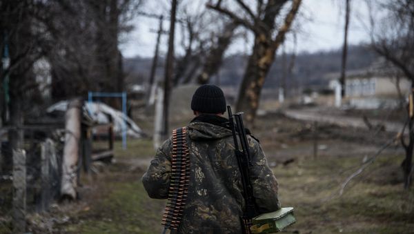 Independence supporter  walks along their position at the frontline in a village not far form Luhasnk, eastern Ukraine, Thursday, March 12, 2015 - Sputnik International