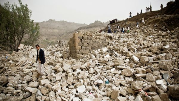 Yemenis stand amid the rubble of houses destroyed by Saudi-led airstrikes in a village near Sanaa, Yemen, Saturday, April 4, 2015 Yemenis stand amid the rubble of houses destroyed by Saudi-led airstrikes in a village near Sanaa, Yemen, Saturday, April 4, 2015 - Sputnik International
