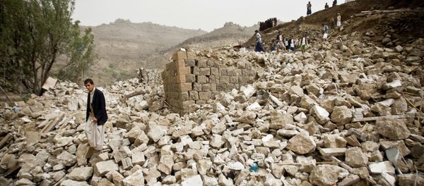 Yemenis stand amid the rubble of houses destroyed by Saudi-led airstrikes in a village near Sanaa, Yemen, Saturday, April 4, 2015 Yemenis stand amid the rubble of houses destroyed by Saudi-led airstrikes in a village near Sanaa, Yemen, Saturday, April 4, 2015 - Sputnik International