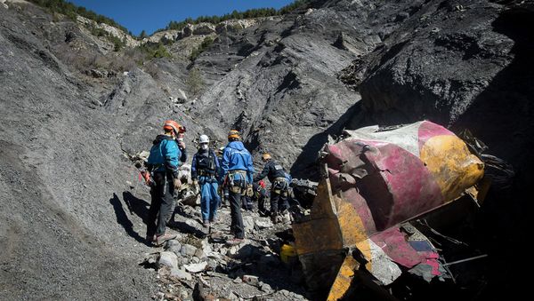 Rescue workers and investigators, seen in this picture made available to the media by the French Interior Ministry April 1, 2015, work near debris from wreckage at the crash site of a Germanwings Airbus A320, near Seyne-les-Alpes. - Sputnik International