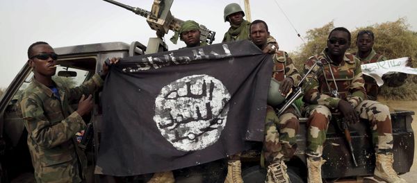 Nigerien soldiers hold up a Boko Haram flag that they had seized in the recently retaken town of Damasak, Nigeria, March 18, 2015 Nigerien soldiers hold up a Boko Haram flag that they had seized in the recently retaken town of Damasak, Nigeria, March 18, 2015 - Sputnik International