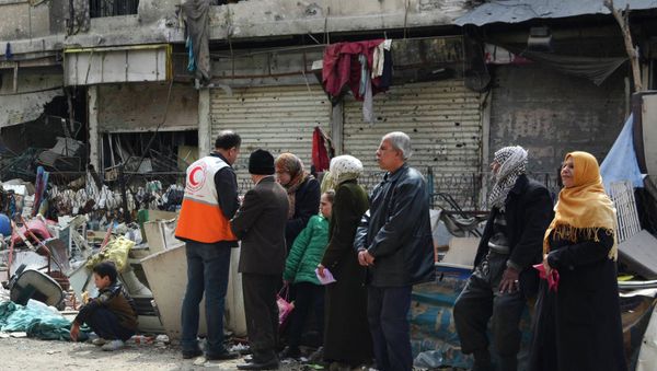 Residents wait to receive humanitarian aid at the Palestinian refugee camp of Yarmouk, in Damascus March 11, 2015 Residents wait to receive humanitarian aid at the Palestinian refugee camp of Yarmouk, in Damascus March 11, 2015 - Sputnik International