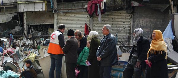 Residents wait to receive humanitarian aid at the Palestinian refugee camp of Yarmouk, in Damascus March 11, 2015 - Sputnik International