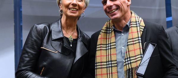 Greek Finance Minister Yanis Varoufakis (R) shakes hands with International Monetary Fund (IMF) Director Christine Lagarde during an emergency Eurogroup finance ministers meeting at the European Council in Brussels on February 11, 2015 - Sputnik International