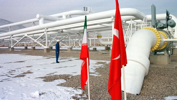 An Iranian worker stands in front of gas pipelines next to the flags of Turkey (R) and Iran An Iranian worker stands in front of gas pipelines next to the flags of Turkey (R) and Iran - Sputnik International