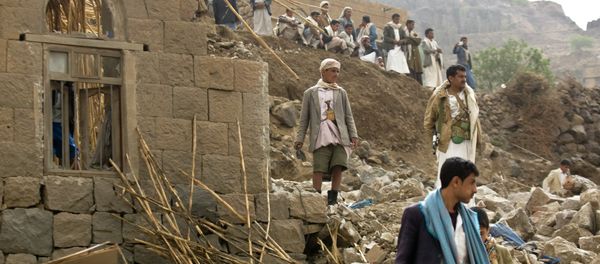 In this Saturday, April 4, 2015 file photo, Yemenis stand amid the rubble of houses destroyed by Saudi-led airstrikes in a village near Sanaa, Yemen In this Saturday, April 4, 2015 file photo, Yemenis stand amid the rubble of houses destroyed by Saudi-led airstrikes in a village near Sanaa, Yemen - Sputnik International