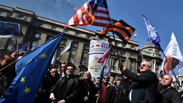 Serbian nationalist politician Vojislav Seselj (2nd R) holds a burning US flag flanked by supporters during an anti-government rally in Belgrade on March 24, 2015 Serbian nationalist politician Vojislav Seselj (2nd R) holds a burning US flag flanked by supporters during an anti-government rally in Belgrade on March 24, 2015 - Sputnik International