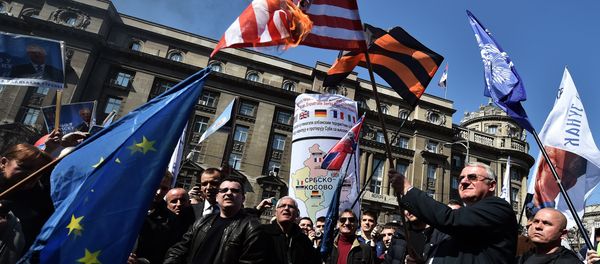 Serbian nationalist politician Vojislav Seselj (2nd R) holds a burning US flag flanked by supporters during an anti-government rally in Belgrade on March 24, 2015 Serbian nationalist politician Vojislav Seselj (2nd R) holds a burning US flag flanked by supporters during an anti-government rally in Belgrade on March 24, 2015 - Sputnik International
