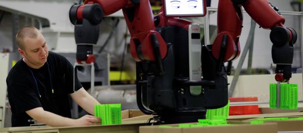 A technician works with Baxter, an adaptive manufacturing robot created by Rethink Robotics at The Rodon Group manufacturing facility, Tuesday, March 12, 2013, in Hatfield, Pa. - Sputnik International
