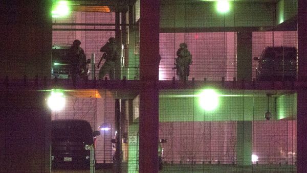 Police search a parking garage on the U.S. Census Bureau headquarters campus for an armed man who, according to a fire official, shot a security guard at a gate to the facility in Suitland, Md. - Sputnik International