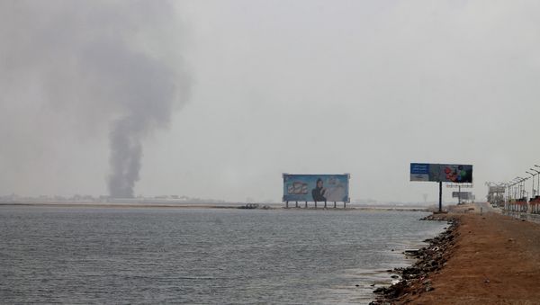 A general view shows smoke rising from the Khor Maksar neighbourhood next to the airport, in southern Yemeni city of Aden A general view shows smoke rising from the Khor Maksar neighbourhood next to the airport, in southern Yemeni city of Aden - Sputnik International